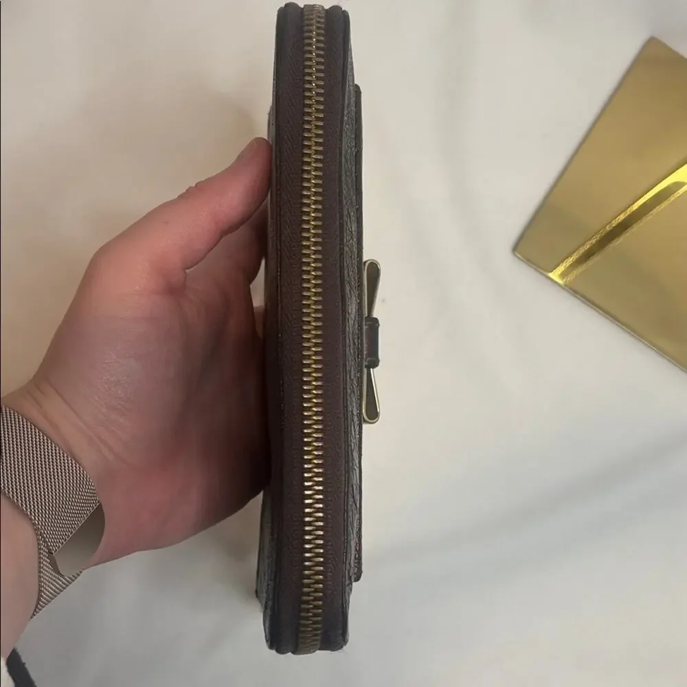 Chloe Lilly bow front long wallet in a metallic maroon brown